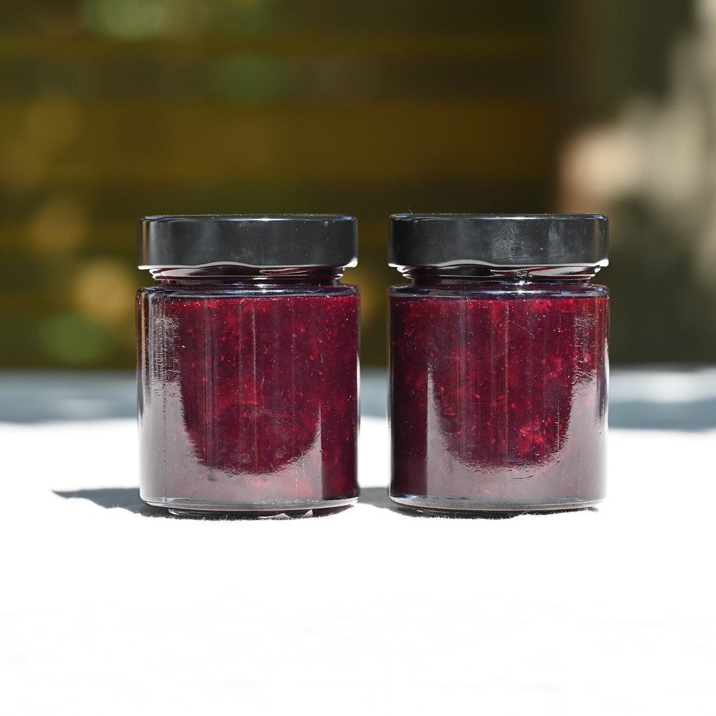 Two jars of blueberry and gin jam