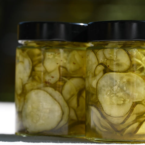 Close up of two jars of bread and butter pickles