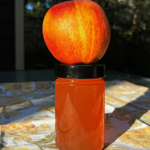 Jar of apply jelly with apple on top