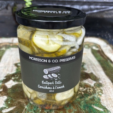 Jar of Morrison & Co ballpark dill pickles with a black lid and label on a textured surface