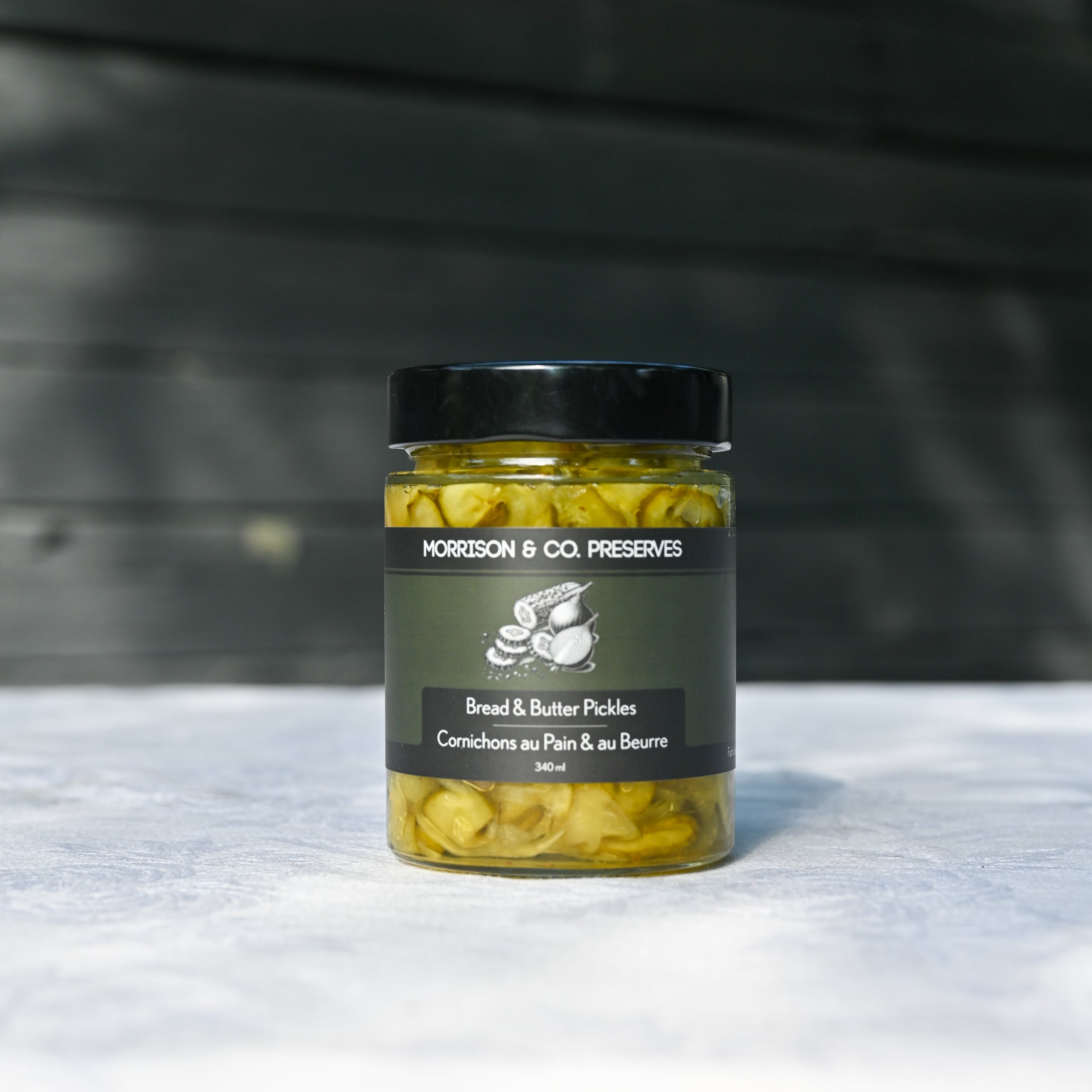 One jar of Morrison & Co Preserves Bread & Butter pickles on a white tablecloth