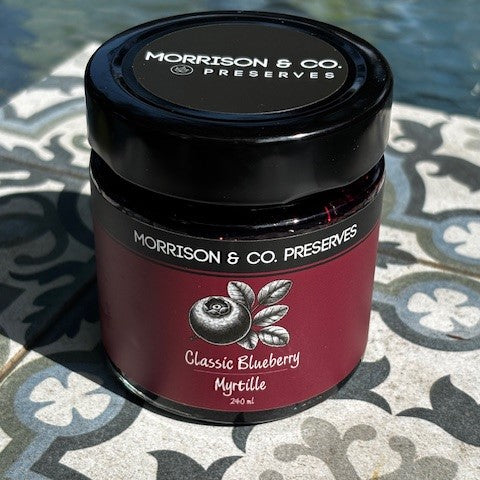 Jar of Morrison & Co Preserves Classic Blueberry jam on a patterned surface